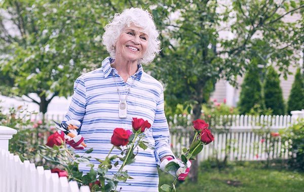 Older Woman gardening roses Philips Lifeline
